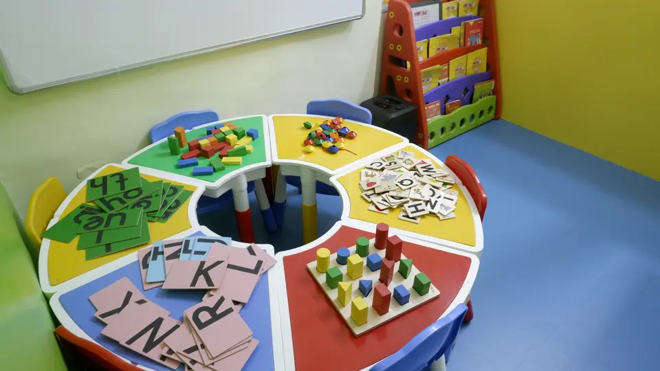 Activity table set with alphabet cards, beads, blocks and shape pegs